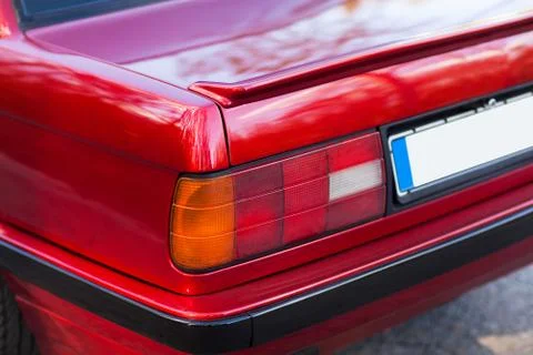 The back of a red retro car with a small wing Stock Photos