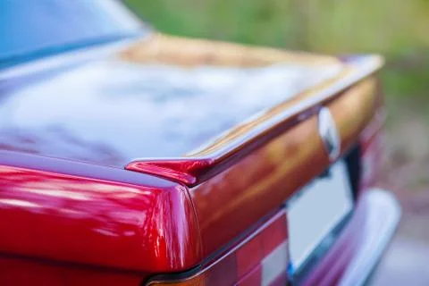 The back of a red retro car with a small wing Stock Photos
