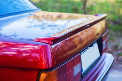The back of a red retro car with a small wing Stock Photos