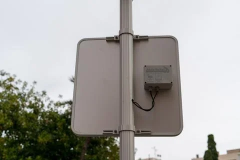 Back of road sign with electronic sensor device on metal pole Stock Photos