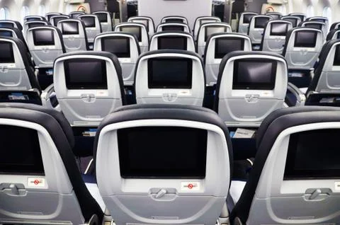 Back of rows of empty airplane seats Stock Photos
