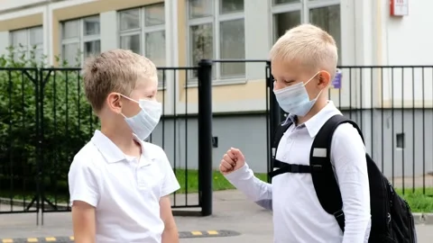 Back to school after quarantine. Cute boys Children say hello contactlessly Stock Footage 157096046