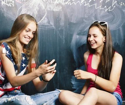 Back to school after summer vacations, two teen girls in classroom with Foto stock