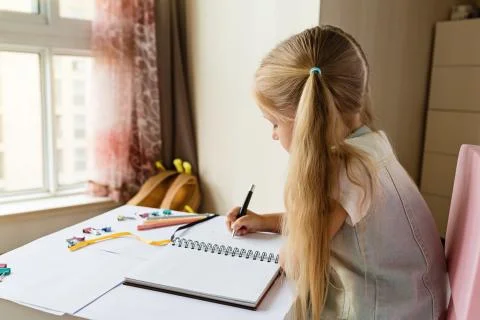 Back to school and happy time. Children holding pen and writting in notebook Stock Photos