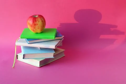 Back to school, apple on a stack of books, bright background Stock Photos