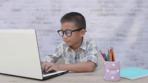 Back to School. asian boy using his laptop to learning online. Stock Footage 117290528