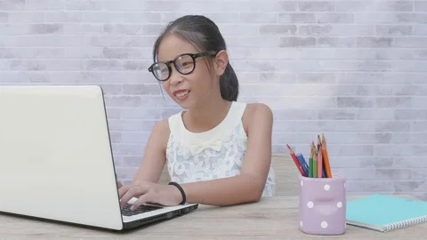 Back to School. asian girl using his laptop to learning online. Stock Footage 117391712