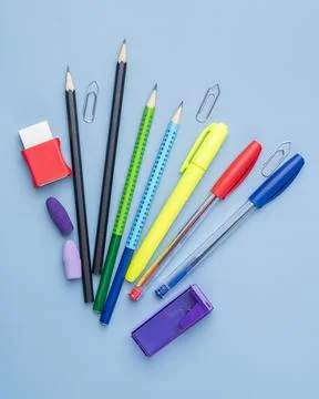 Back to school backdrop. School supply over light blue background Stock Photos