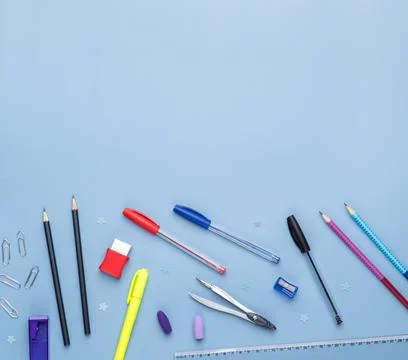 Back to school backdrop. School supply over light blue background with copy.. Stock Photos