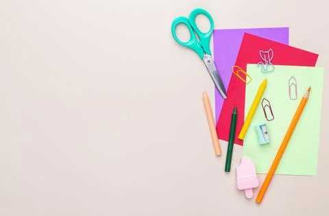 Back to school backdrop. School supply over light brown background with cop.. Stock Photos