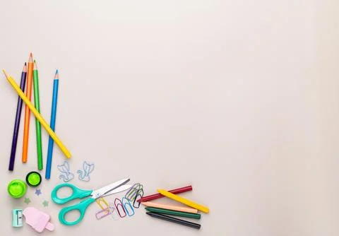 Back to school backdrop. School supply over light brown background with cop.. Stock Photos