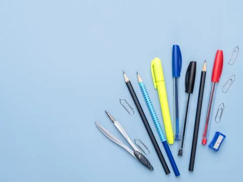 Back to school backdrop. School supply over light blue background with copy.. Stock Photos