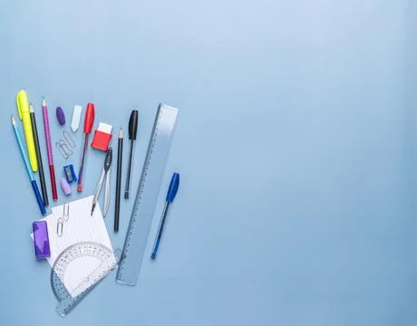 Back to school backdrop. School supply over light blue background with copy.. Stock Photos