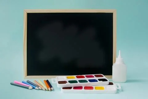 Back to school background with accessories - pencils, paints, glue, school board Stock Photos