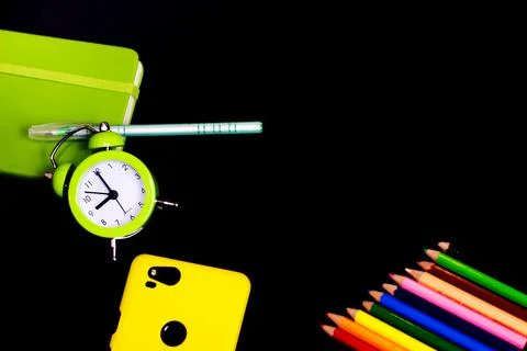 Back to school background with colored pencils and alarm clock. Concept with  Stock Photos