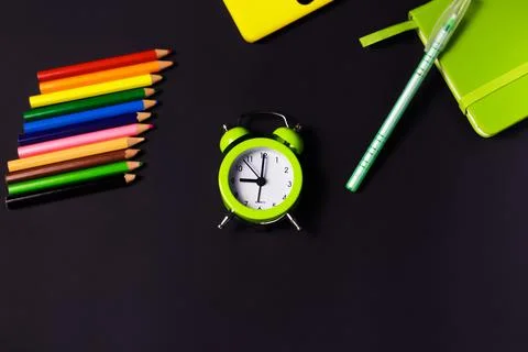 Back to school background with colored pencils and alarm clock. Concept with  Stock Photos