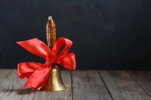 Back to school background. hand bell on first of September on blackboard Stock Photos