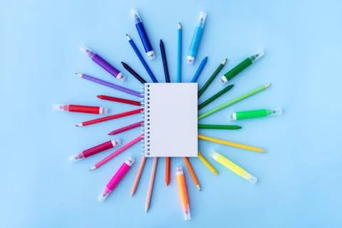 Back to school background with notepad and variety of school supplies in rainbow Stock Photos