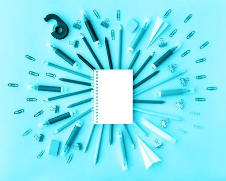 Back to school background with opened notepad and variety of school supplies in Stock Photos