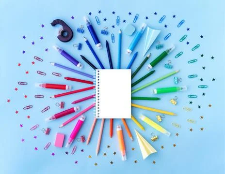 Back to school background with opened notepad and variety of school supplies in Stock Photos