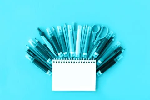 Back to school background with opened notepad and variety of school supplies in Stock Photos