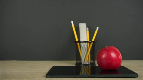 Back to school background with pencils, tablet and apple on it. Stop motion Stock Footage 281514166