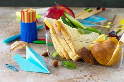 Back to school background. School lunch box, apple and school supplies, origa Stock Photos