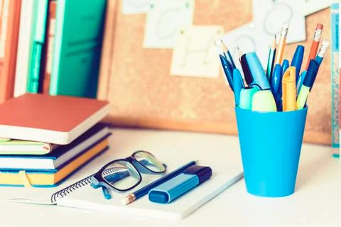 Back to school background. Stationery accessories  notebooks piles, plastic h Stock Photos