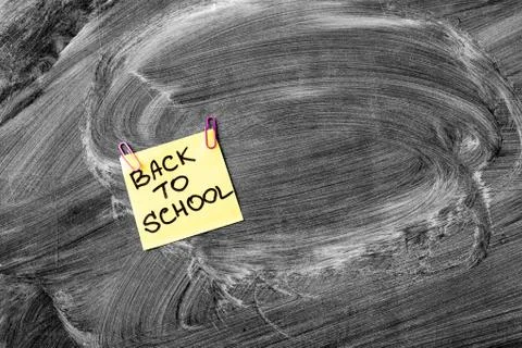 Back to school background with title Back to school on yellow piece of paper on Stock Photos