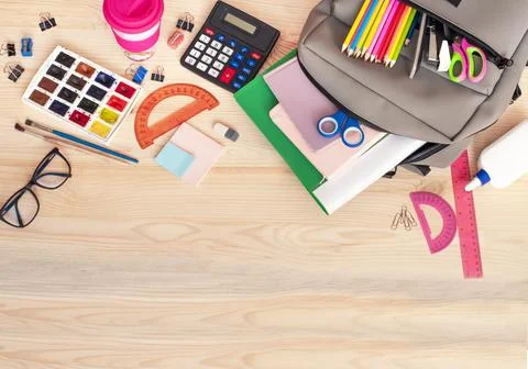 Back to school, backpack with school supplies on a wooden table Stock Photos