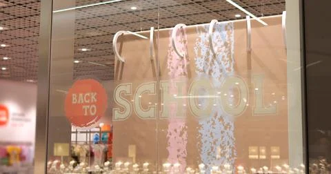 Back to school banner on display window at entrance to children goods store. Stock Photos