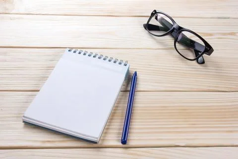 Back to school. Blank note pad, notebook with pen and glasses Stock Photos