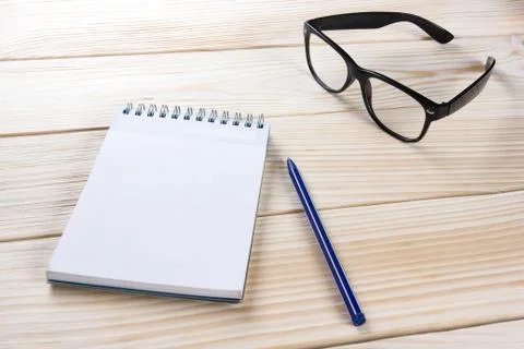 Back to school. Blank note pad, notebook with pen and glasses Stock Photos