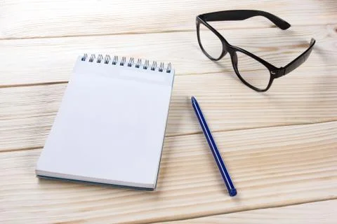 Back to school. Blank note pad, notebook with pen and glasses Stock Photos