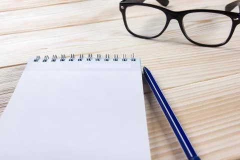 Back to school. Blank note pad, notebook with pen and glasses Stock Photos