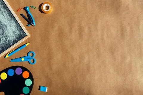 Back to school bright concept, frame with colorful school supplies on brown Stock Photos