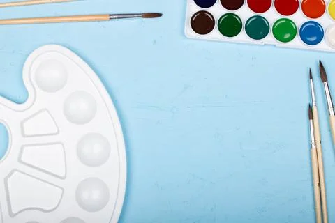 Back to school. Brushes, paints and palette on the table. A set of brushes Stock Photos