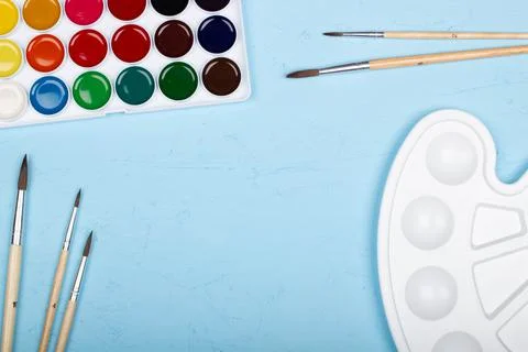 Back to school. Brushes, paints and palette on the table. A set of brushes Stock Photos