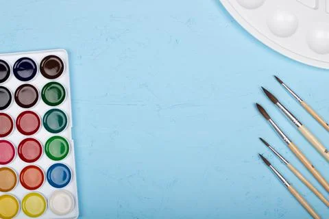 Back to school. Brushes, paints and palette on the table. A set of brushes Stock Photos
