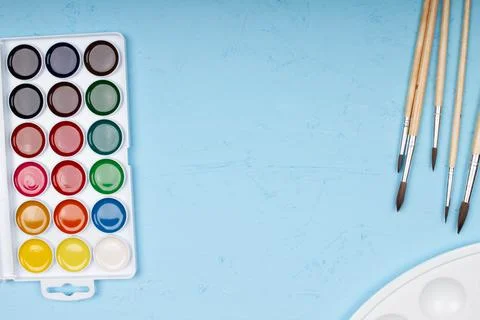 Back to school. Brushes, paints and palette on the table. A set of brushes Stock Photos