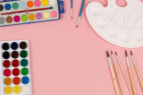 Back to school. Brushes, paints and palette on the table. A set of brushes Stock Photos