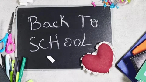 Back to School Chalkboard With Heart and Colorful School Supplies on Desk Flat l Stock Footage 343160620