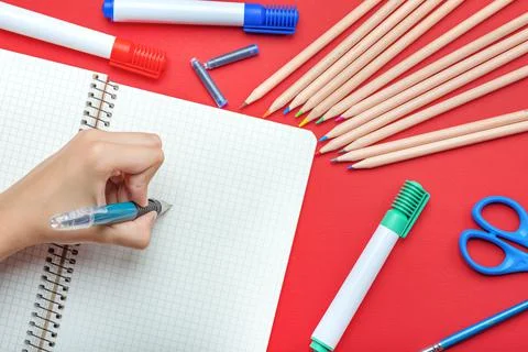 Back to school. The child writes in a notebook with a fountain pen The concept Stock Photos