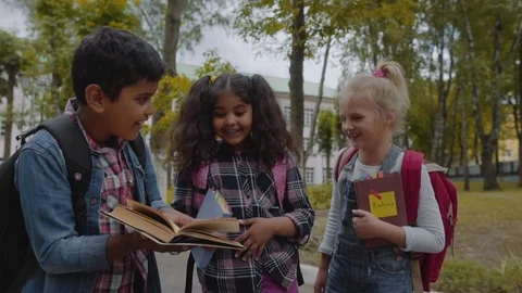 Back to school. Close up Three Friends With Backpacks huging and laughing in Video stock 112669566