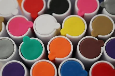 Back to school composition. Colored market caps background. Pen markers multi Stock Photos