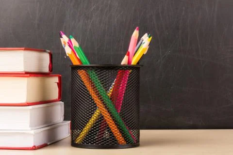Back to school concept and pile of books isolated on black background Stock Photos