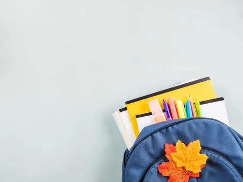 Back to school concept with backpack on blue Stock Photos