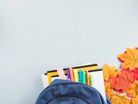Back to school concept with backpack on blue Stock Photos