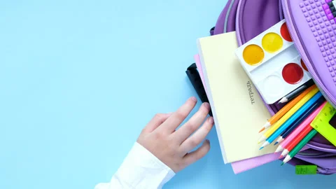 Back to school concept. Backpack with school supplies on blue background. 4K Stock Footage 155409035