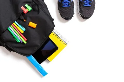 Back to school concept. Backpack with school supplies, tablet and sport sneak Stock Photos